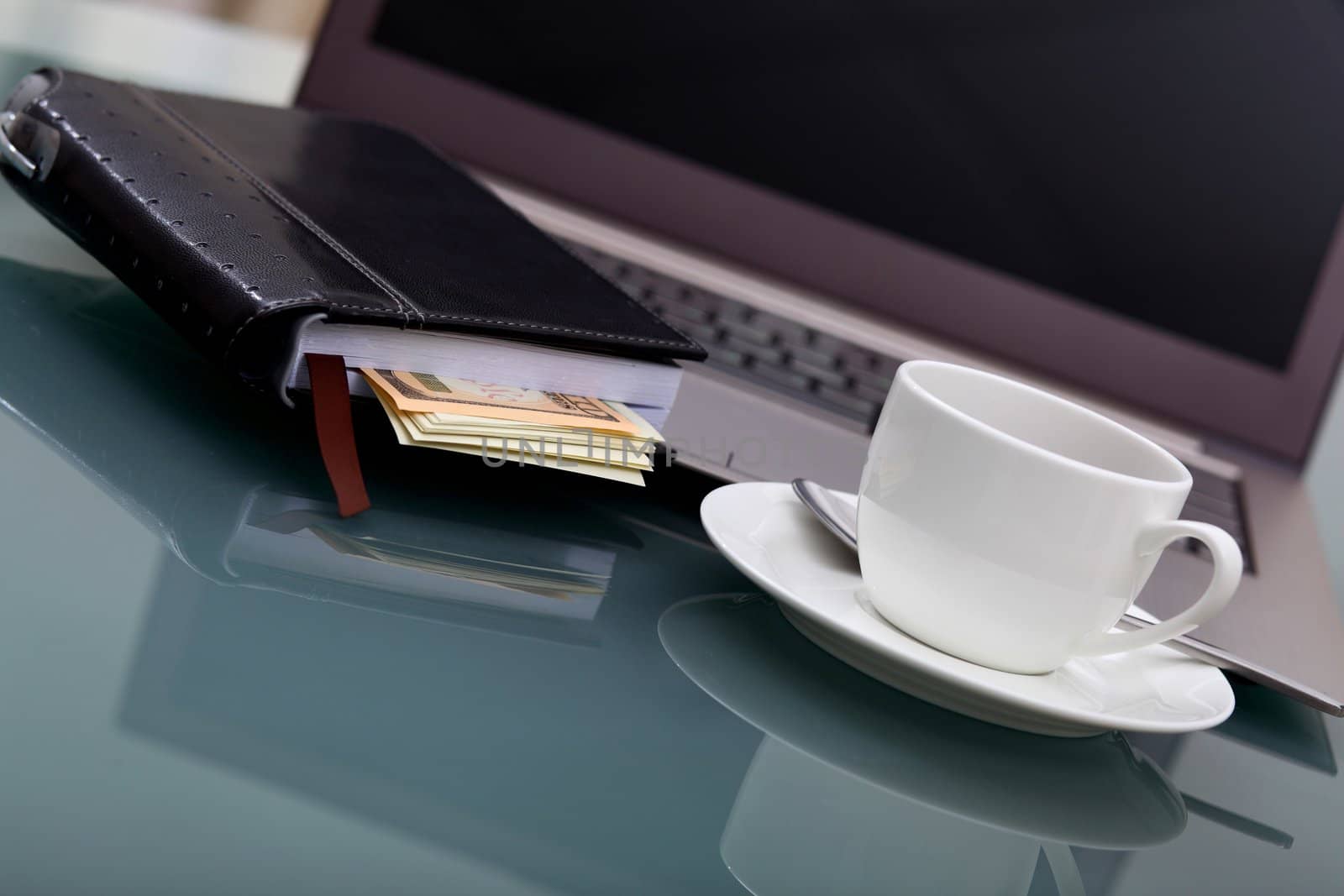 Image of business table with a cup of coffee and norebook