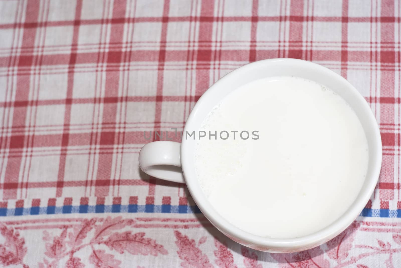 Cup of milk on the table by gandolfocannatella