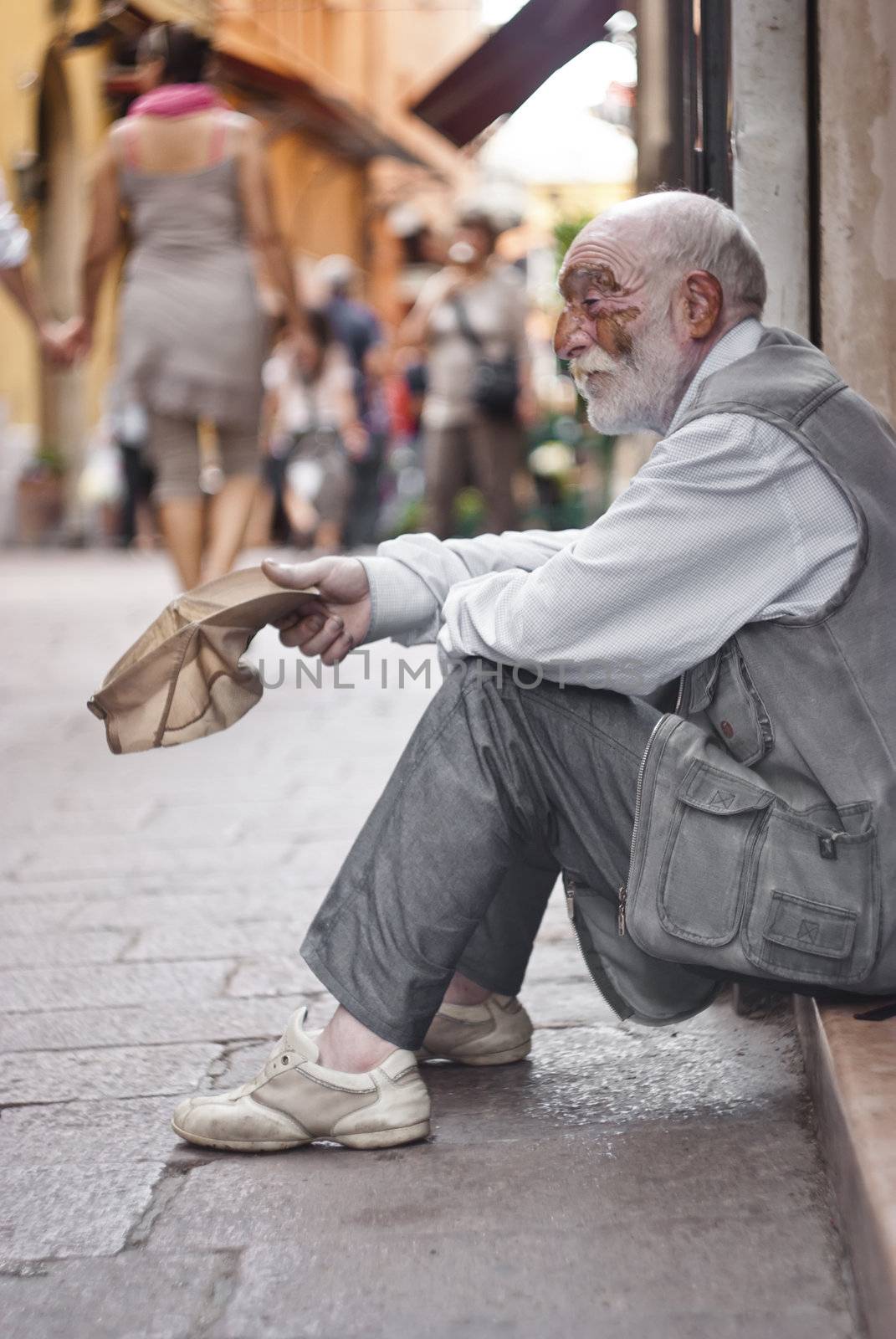 BOLOGNA - JUNE 2012- A homeless old man beggar sitting on the street and asking for help on  May 14, 2011 in BOLOGNA, Italy.