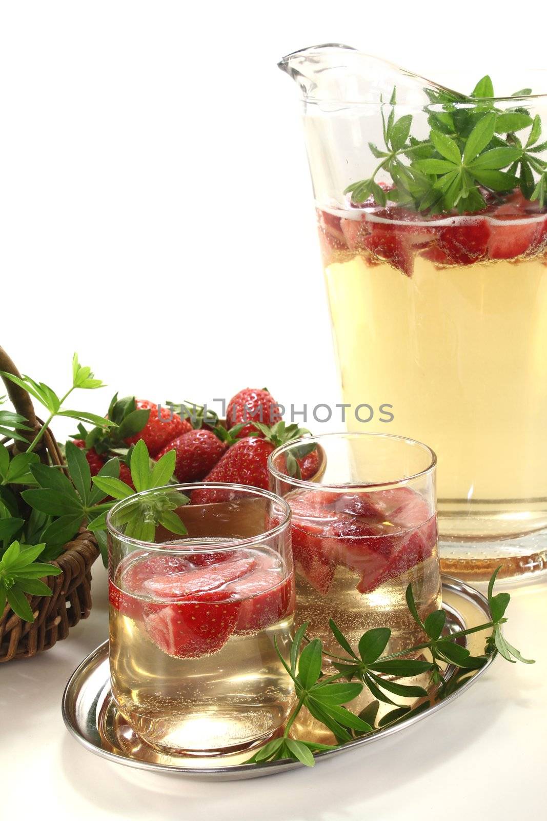 fresh May wine with strawberries and woodruff on a light background