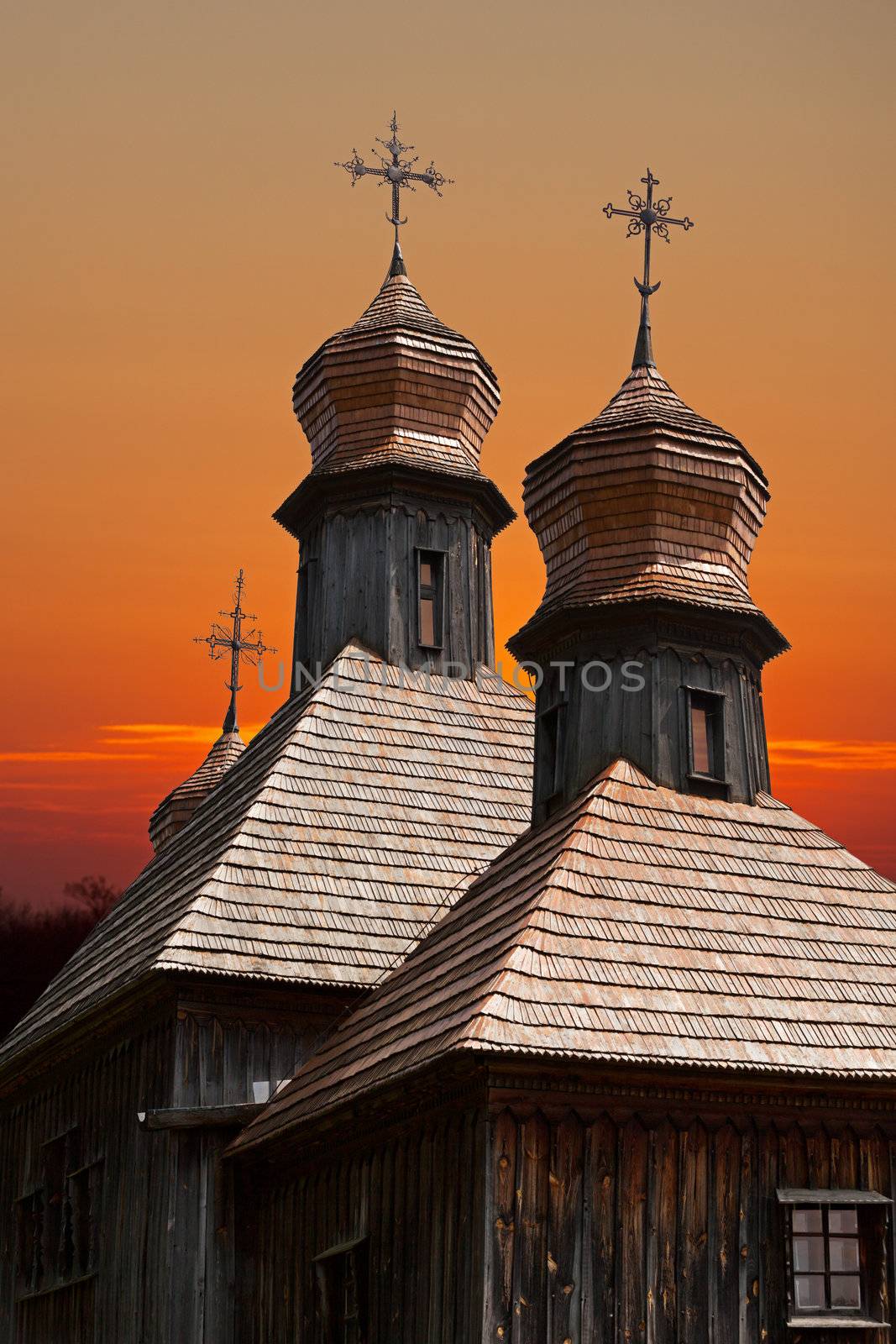 old wooden church against the evening sky