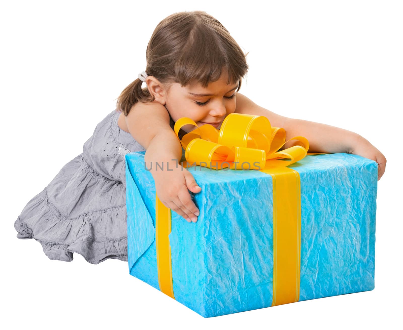 Happy child embraces large birthday gift isolated on white background