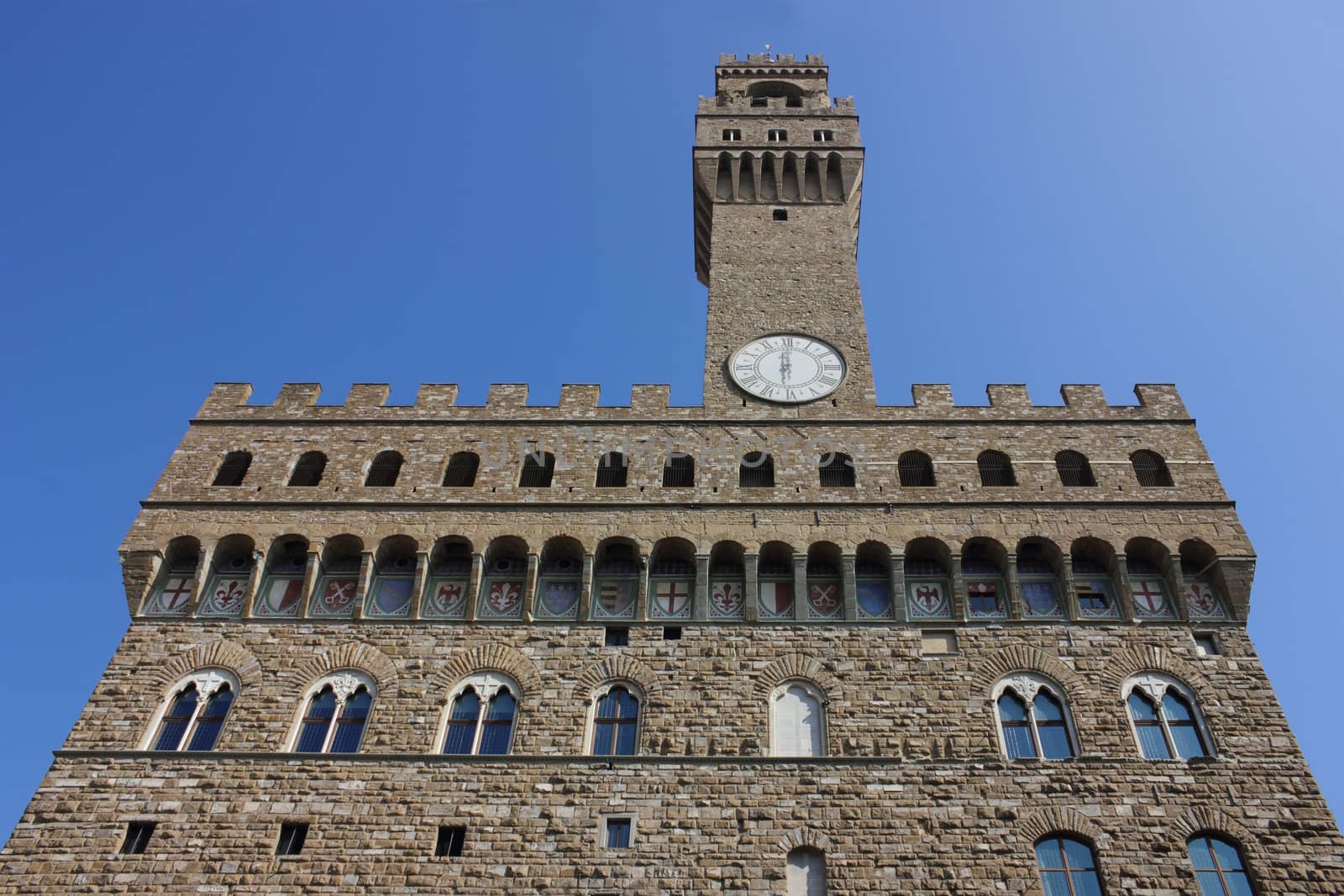 Palazzo Vecchio facade in Florence on clear blue sky background.