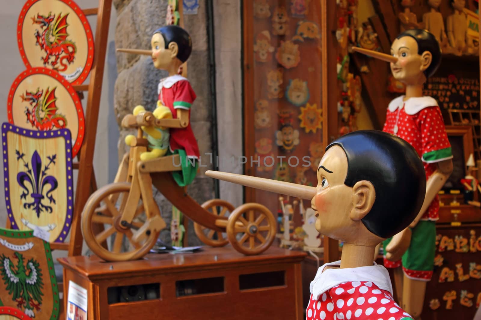 Famous Pinocchio puppets in Italy at the entrance of a souvenirs shop.