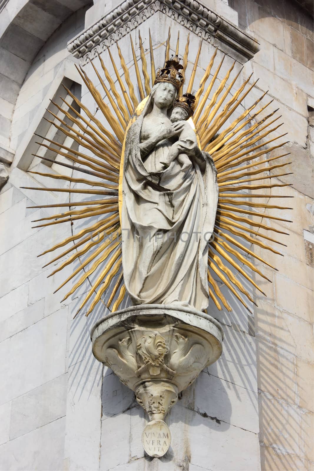 The famous statue of Madonna salutis portus at the corner of the facade of Basilica San Michele in Foro in Lucca.