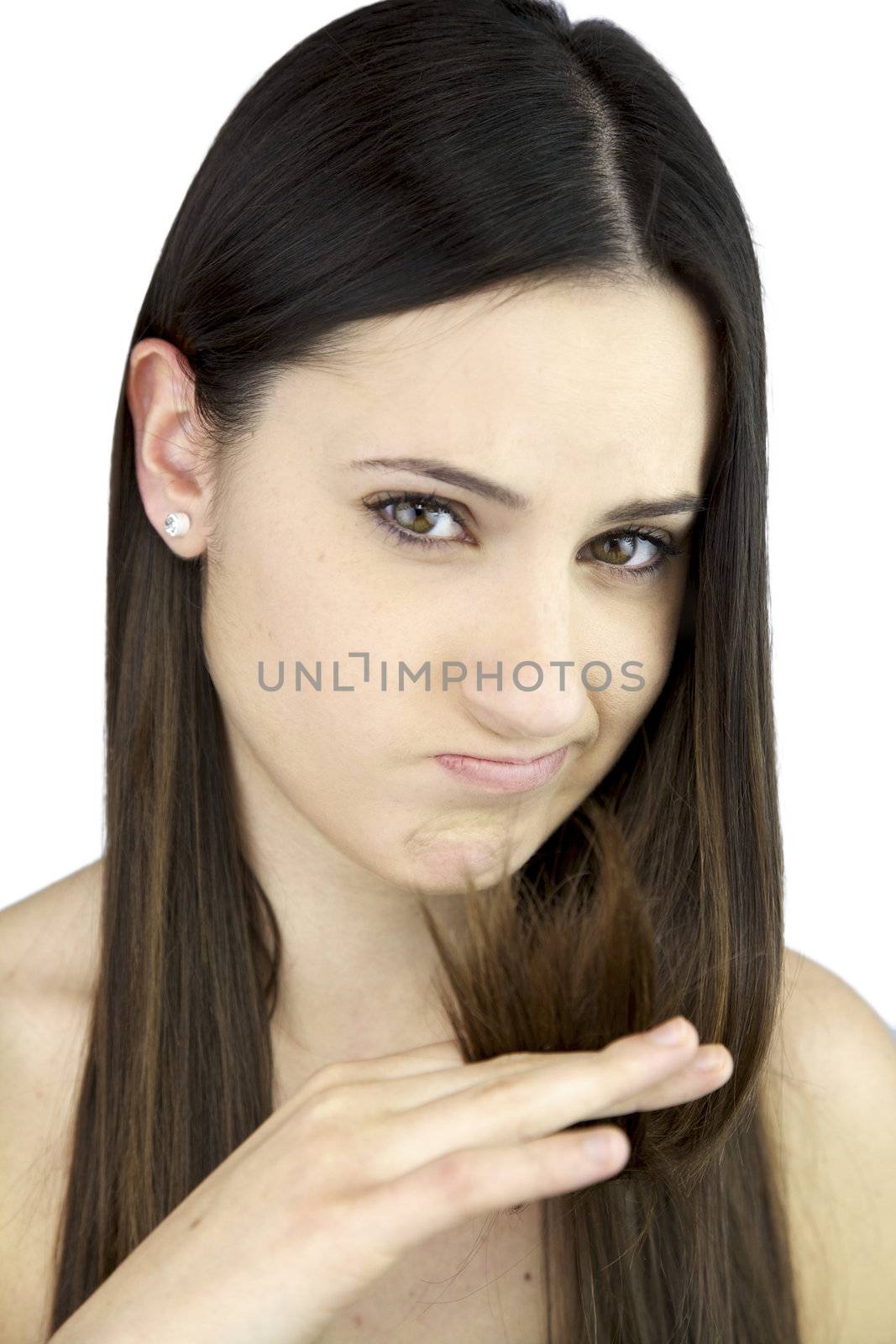 Sad young beautiful female model unhappy about her dead long hair