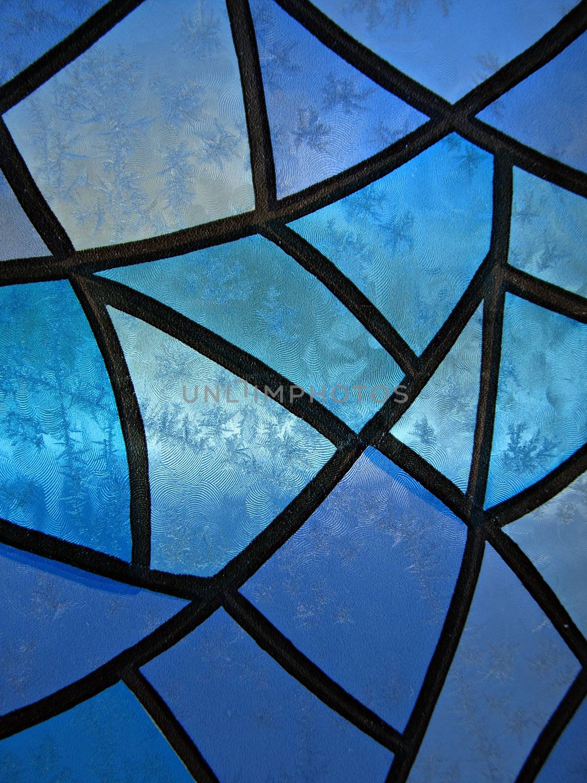 Seasonal Background with stained glass and frozen ice flowers. Close-up shot.