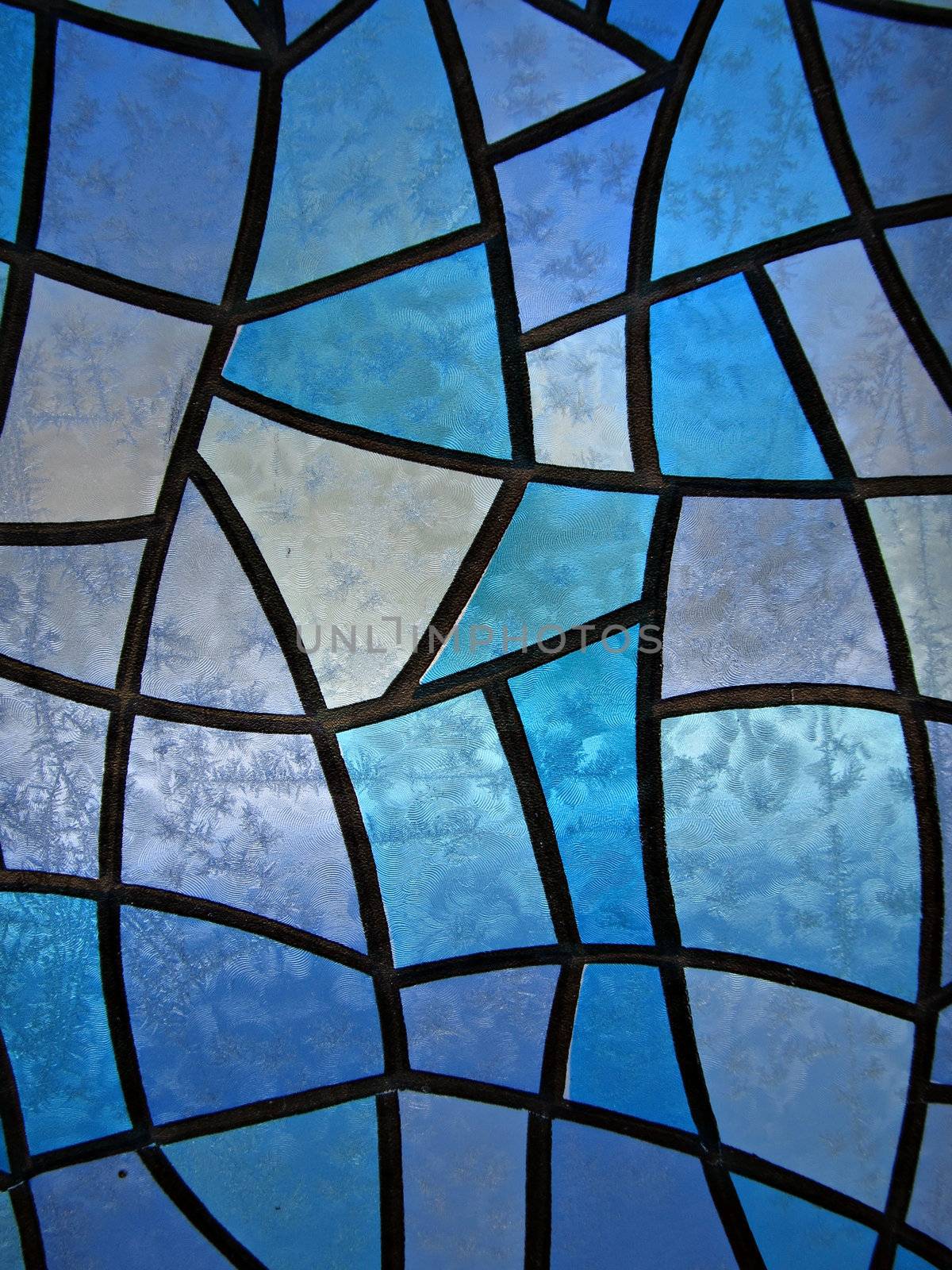 Seasonal Background with stained glass and frozen ice flowers. Distant shot.