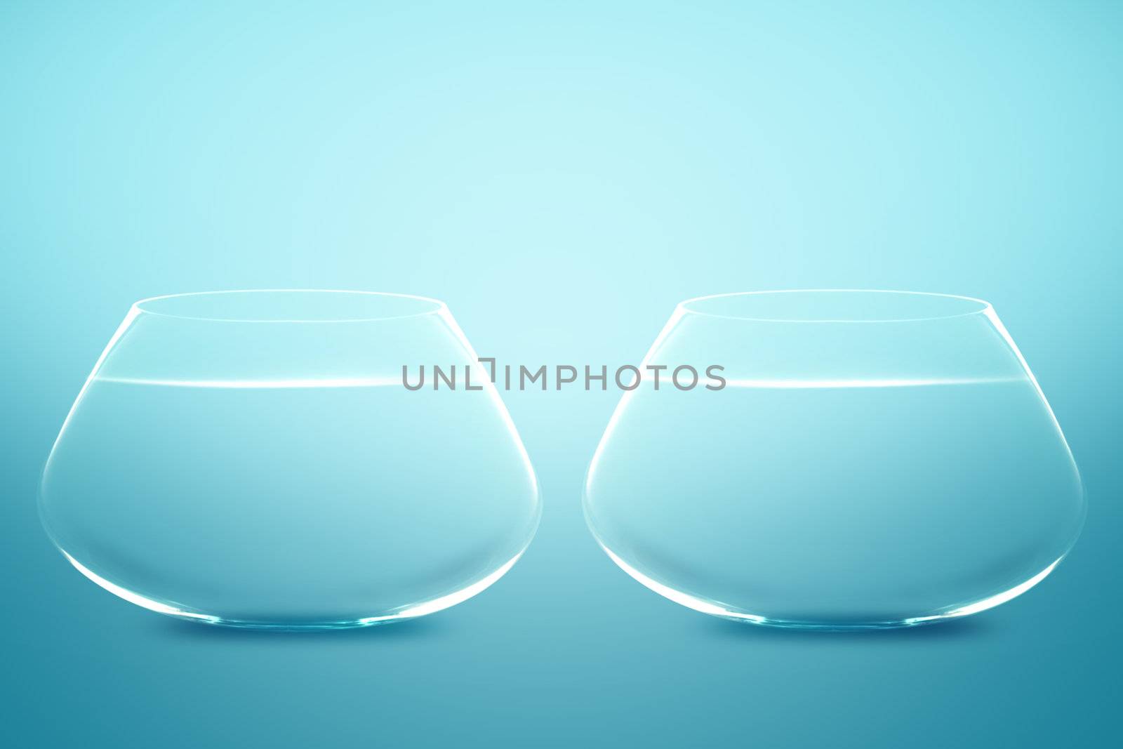 Empty Two fishbowls with water in front of blue background.