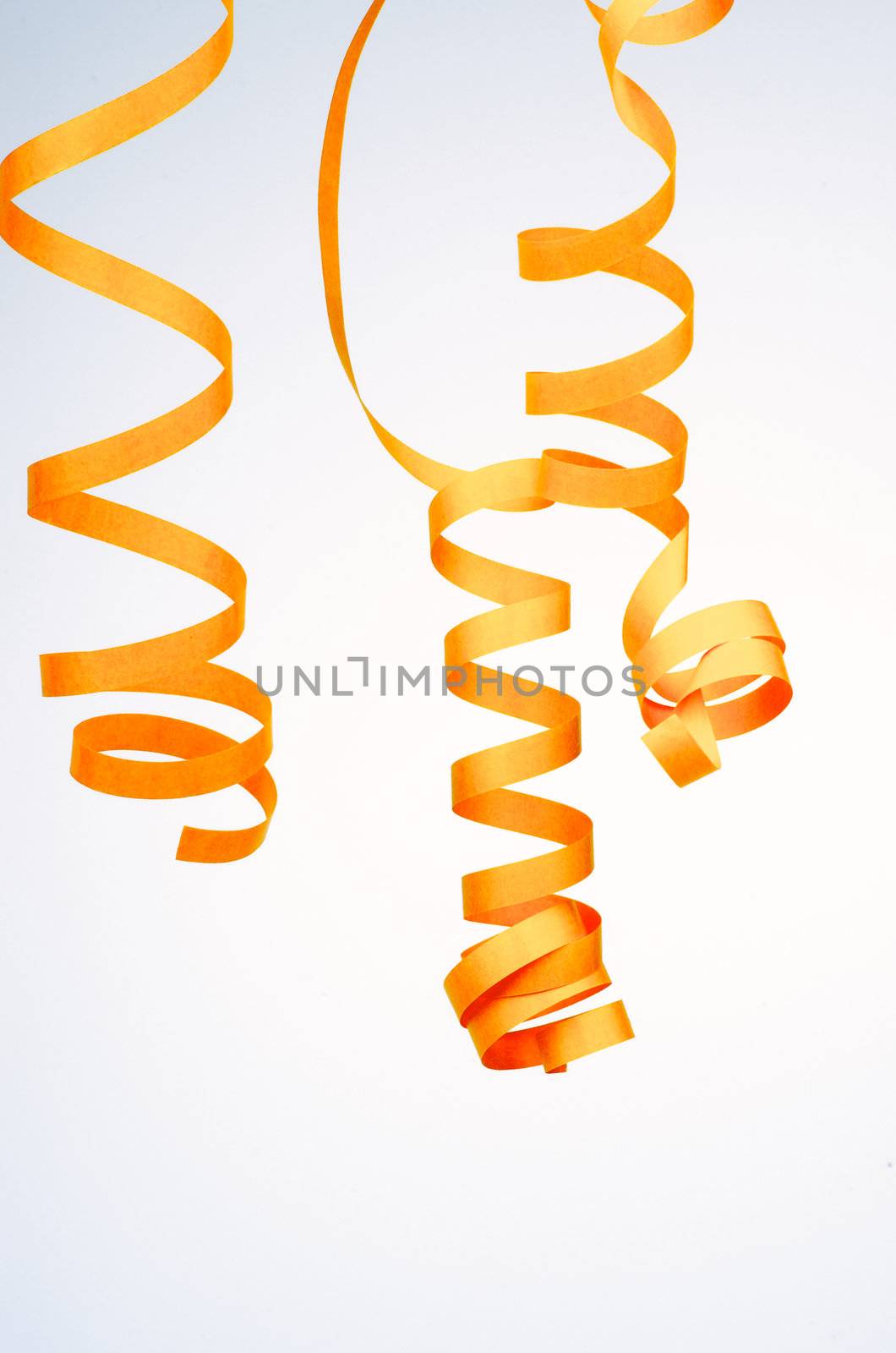 Three Yellow Curl Party Streamers isolated on blue-white background