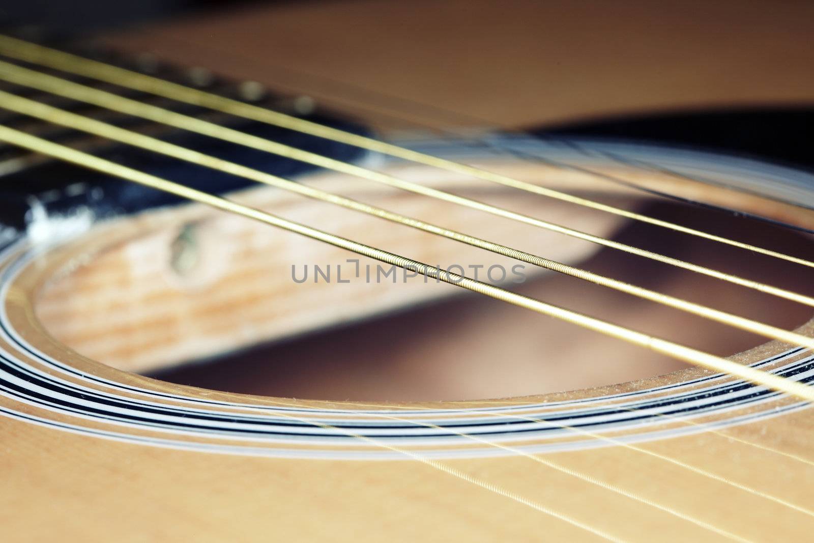 Old acoustic guitar strings. Horizontal close-up photo with shallow depth of field