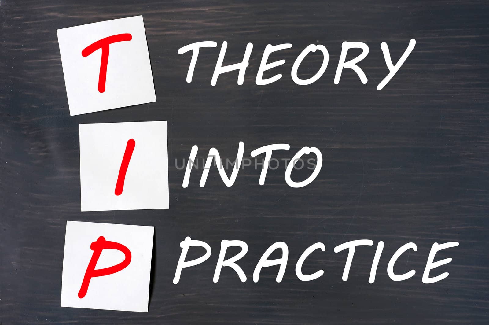 TIP acronym for theory into practice written on a blackboard