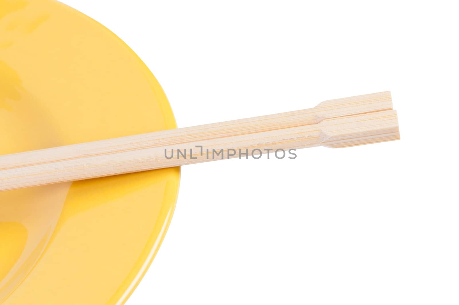 Chopsticks on plate closeup.