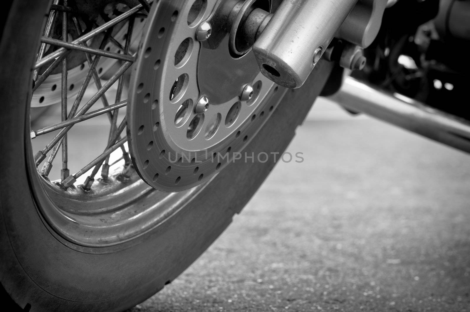 Wheel motorcycle close up, black and white photography. Llow point shooting.