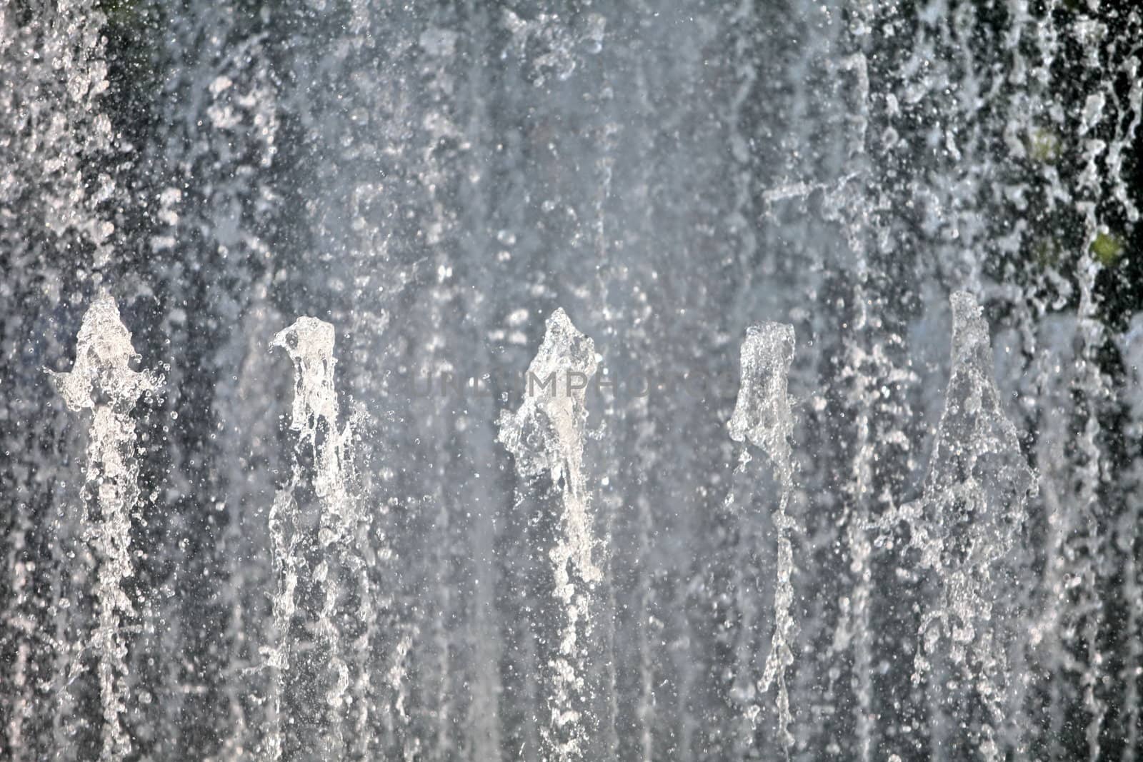 Water wall fountains from spouting vertical background, close-up