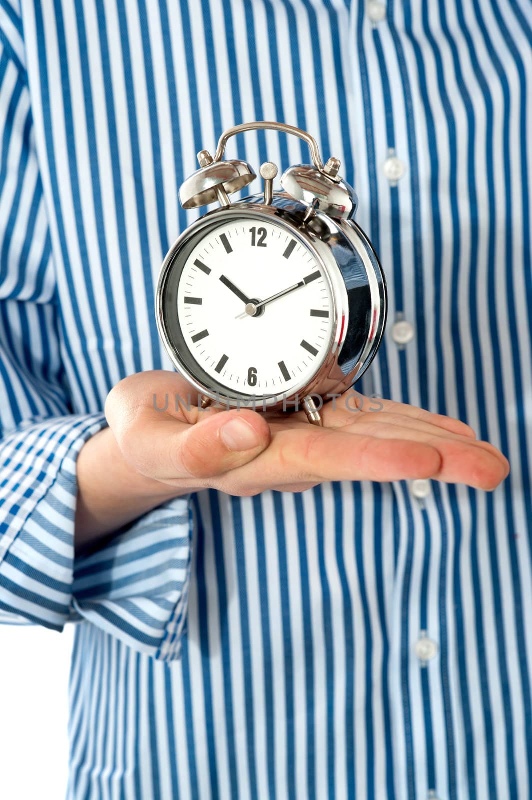 Boys palm holding alarm clock. Focus on clock