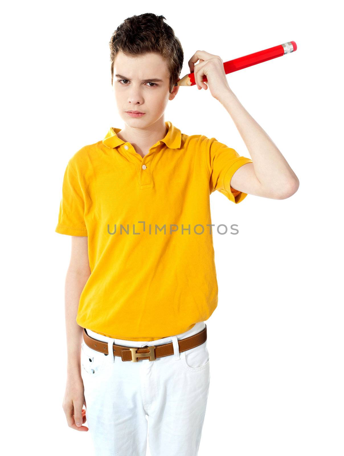 Handsome boy cleaning his ear with the use of big pencil