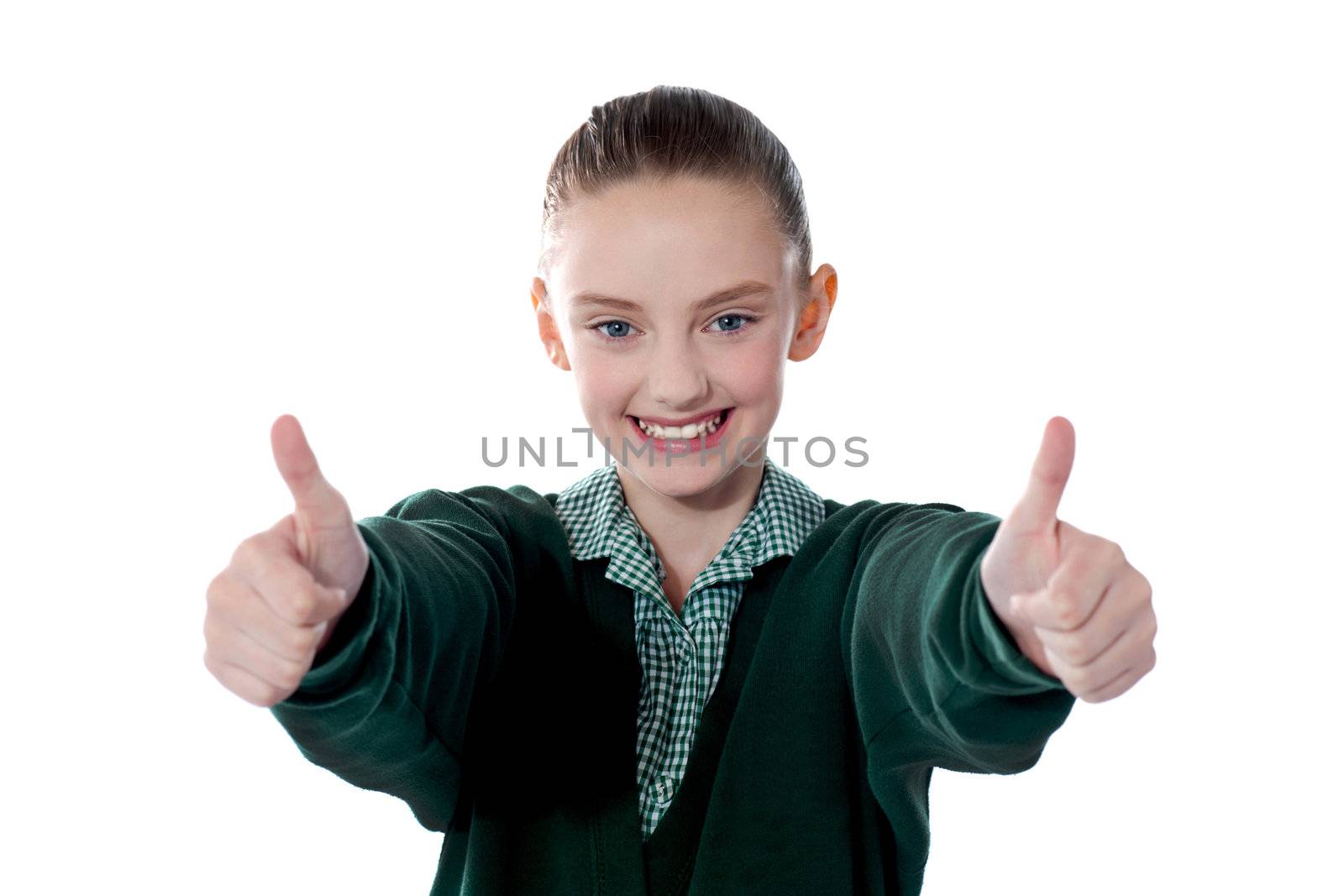 Little girl showing thumbs up to camera. Smiling and filled with joy