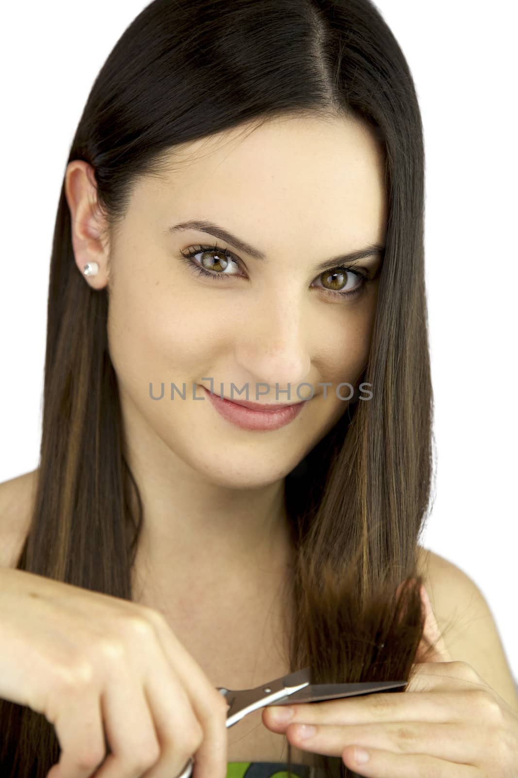Young woman smiling cutting her split ends smiling by fmarsicano