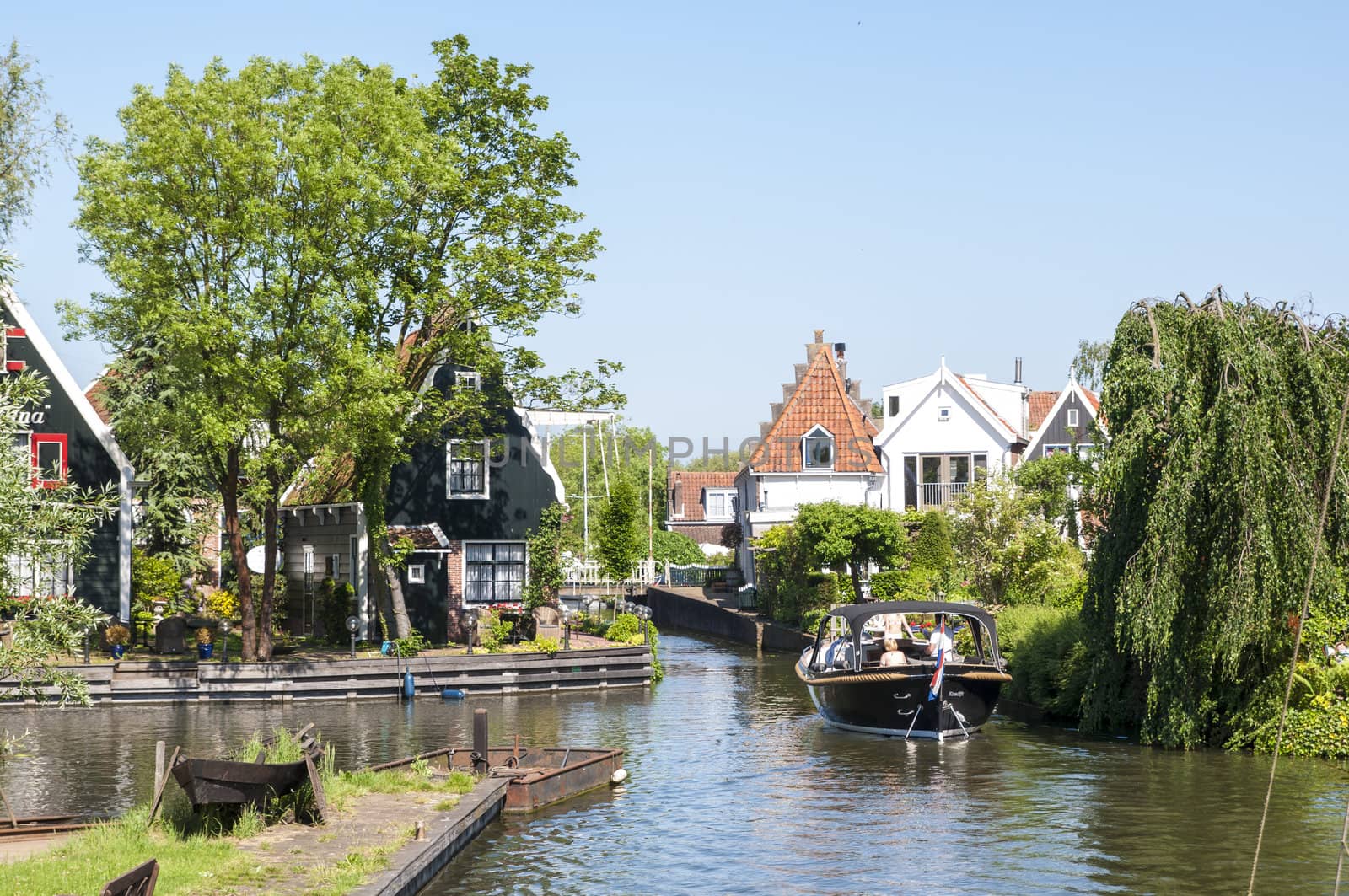 EDAM, HOLLAND - MAY 28: Detail of one of the canal that cross the city, with private boat. May 28, 2012 in Edam.