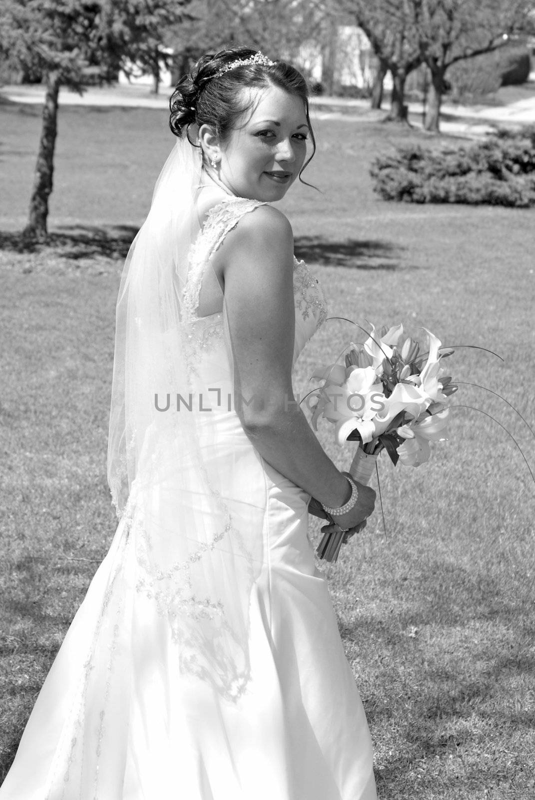 A bride holds her flower bouquet in her hands.