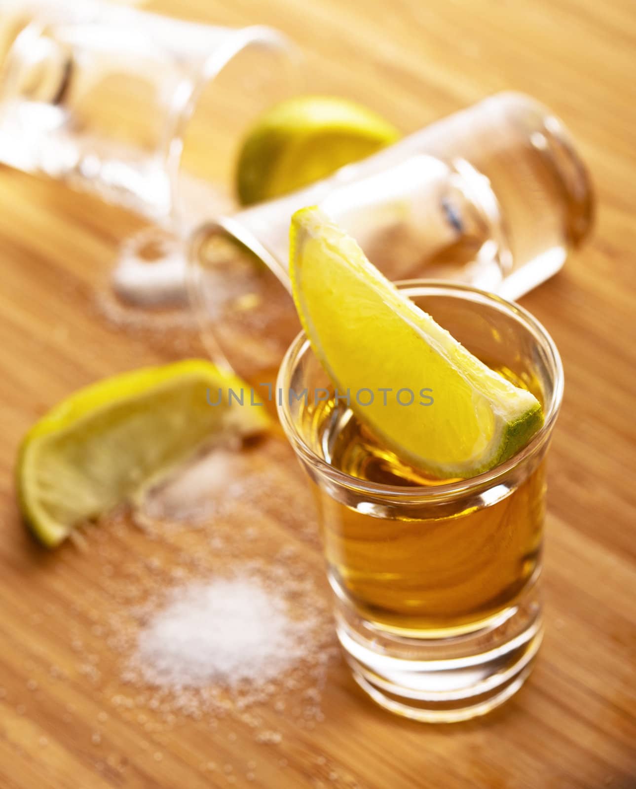 Three shots of tequila with lime and salt