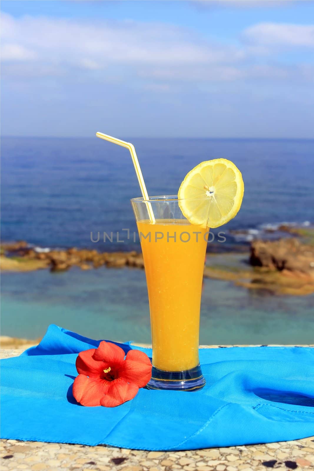 yellow fruit cocktail on the background of a beautiful sea landscape