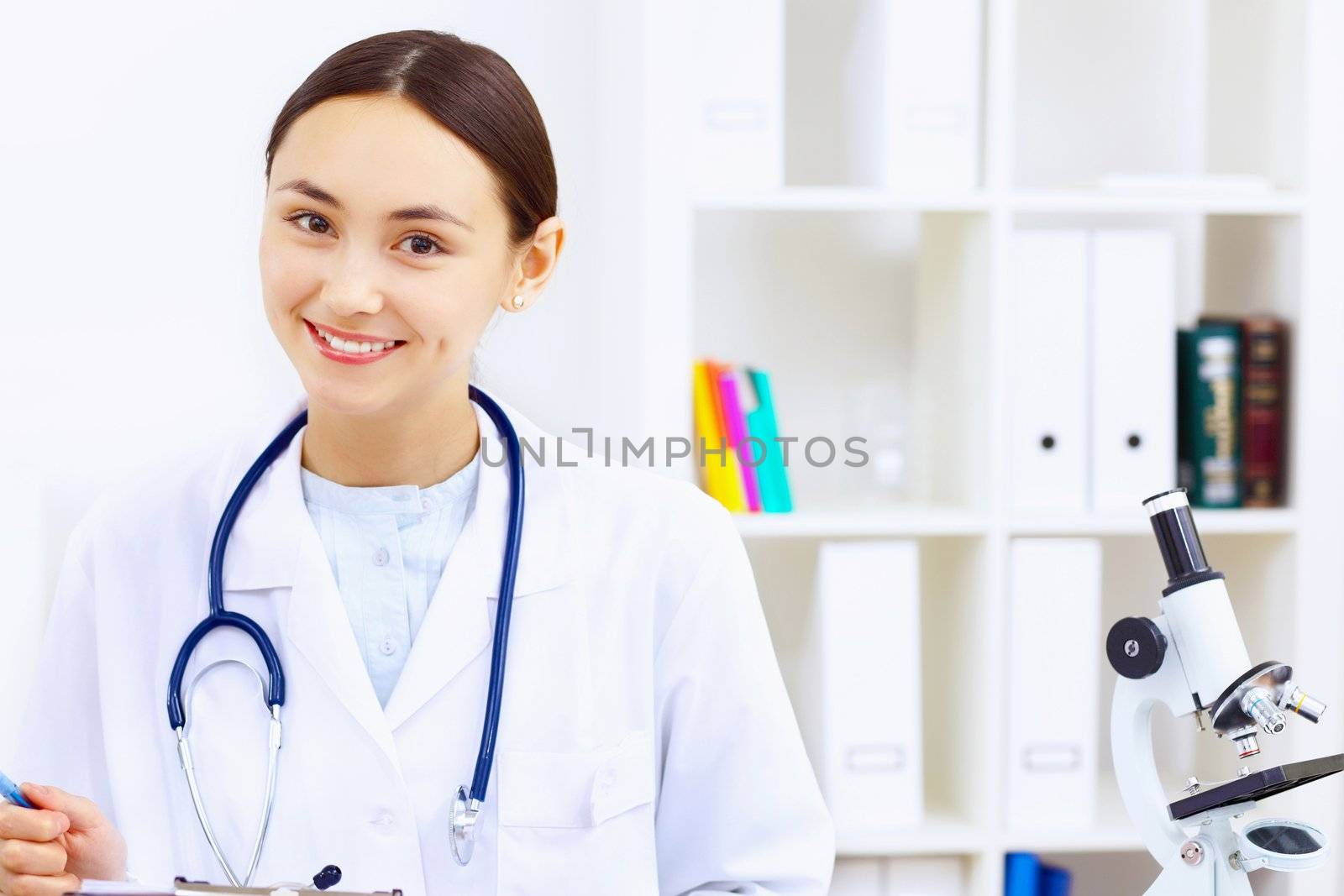 Little girl and young doctor in hospital having examination