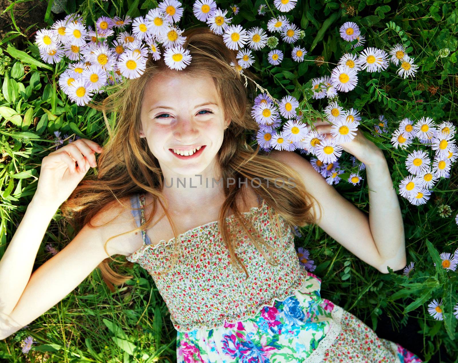 Teen girl lying in grass by AndreyKr