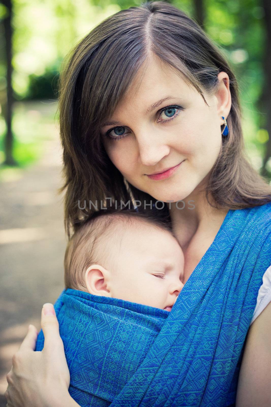 Mother with a newborn baby in a sling