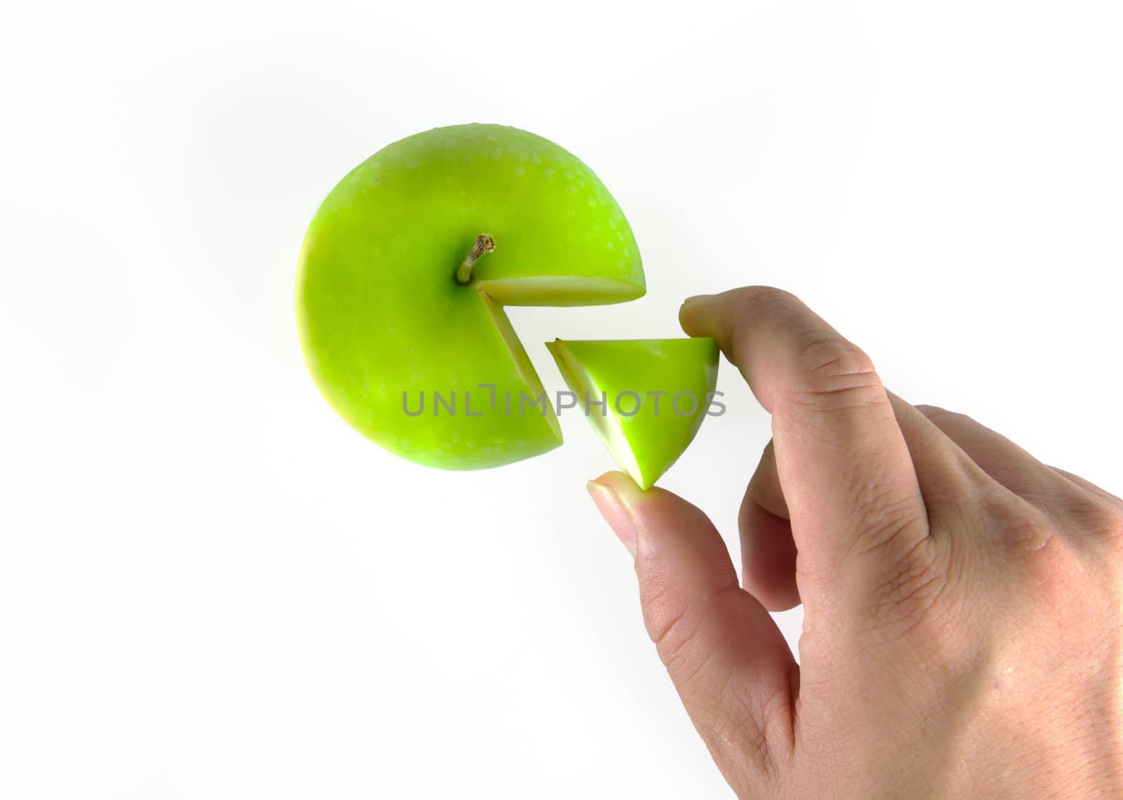 hand got piece of green apple isolated
