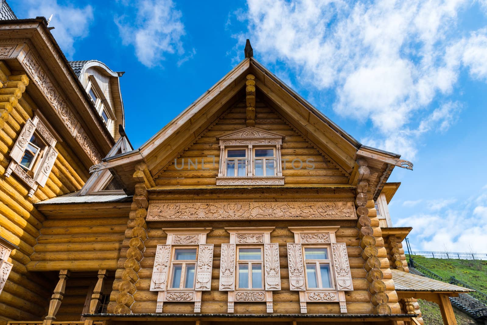 Wooden log house with decorated windows, Russian traditional architecture.