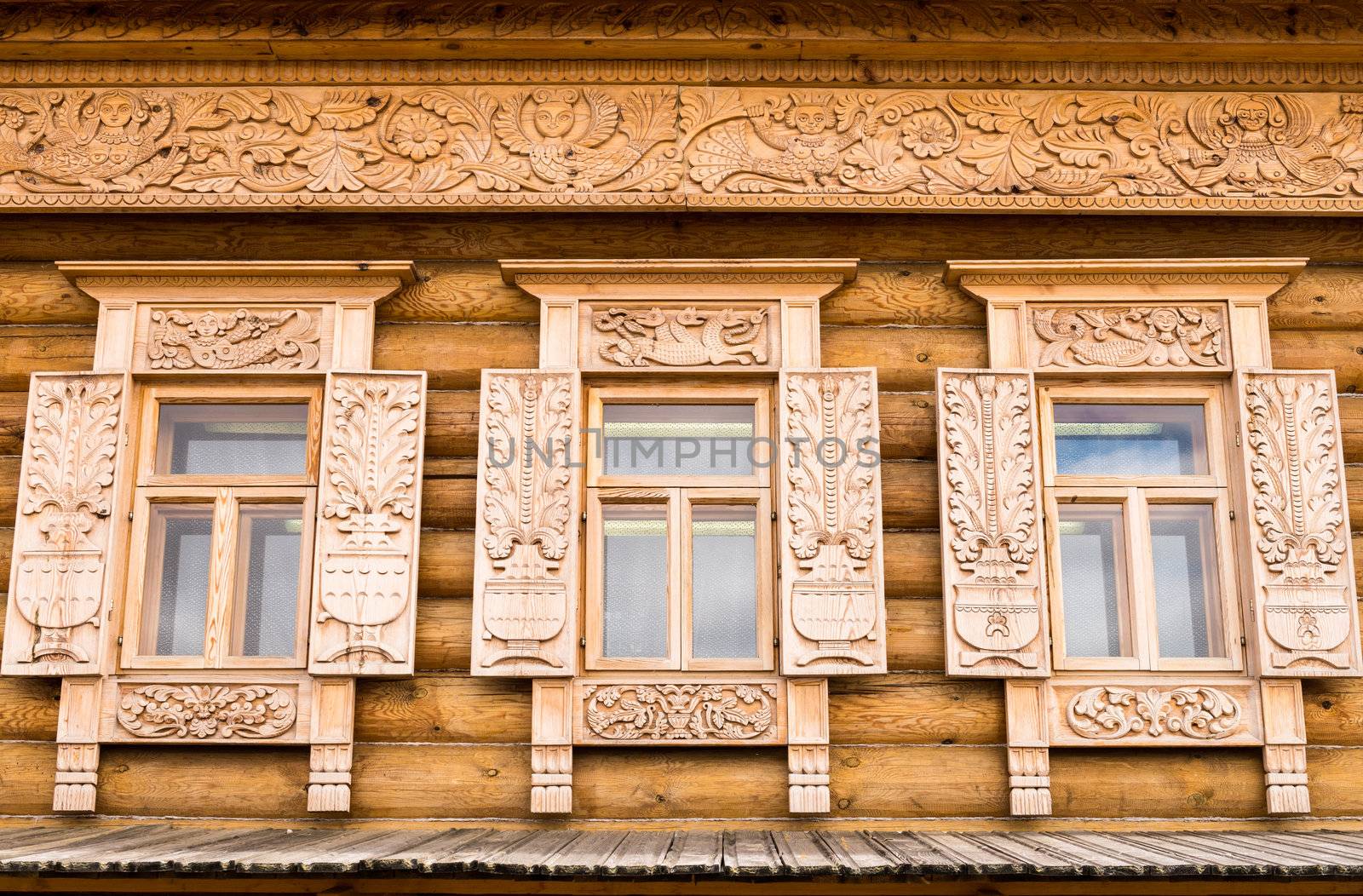 Wooden decorated windows in log house, Russian traditional architecture.