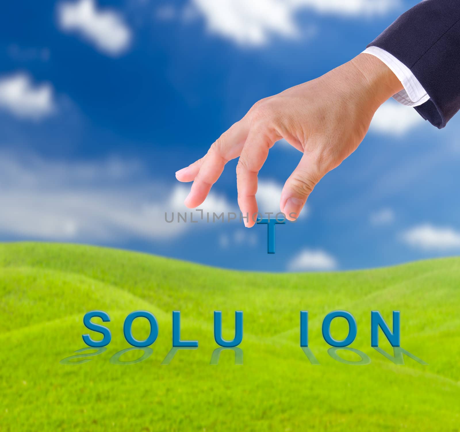 business man hand and solution word on green grass meadow