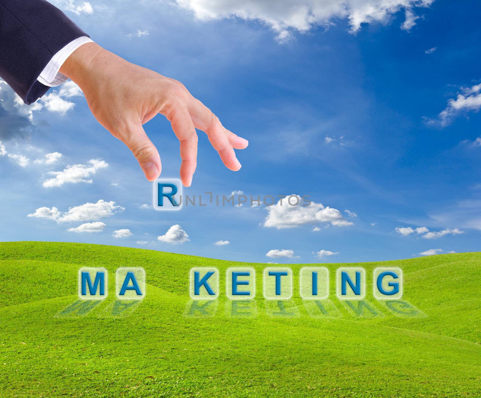 business man hand and marketing word buttons on green grass meadow