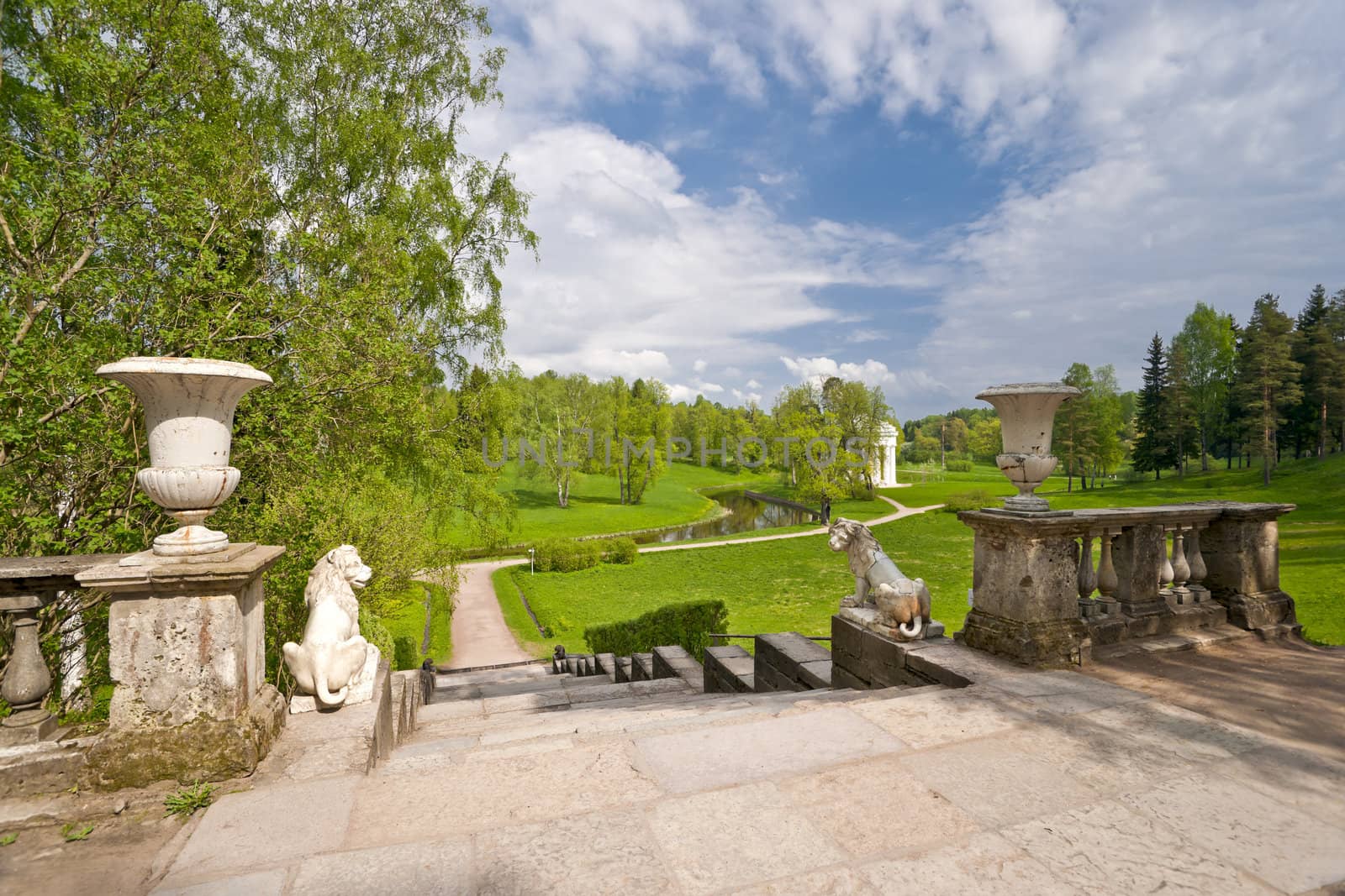 Stairway with lion sculptures to the beautiful classical park