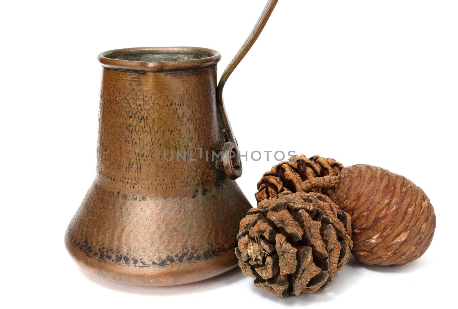 old handmade copper kettle and pine cones