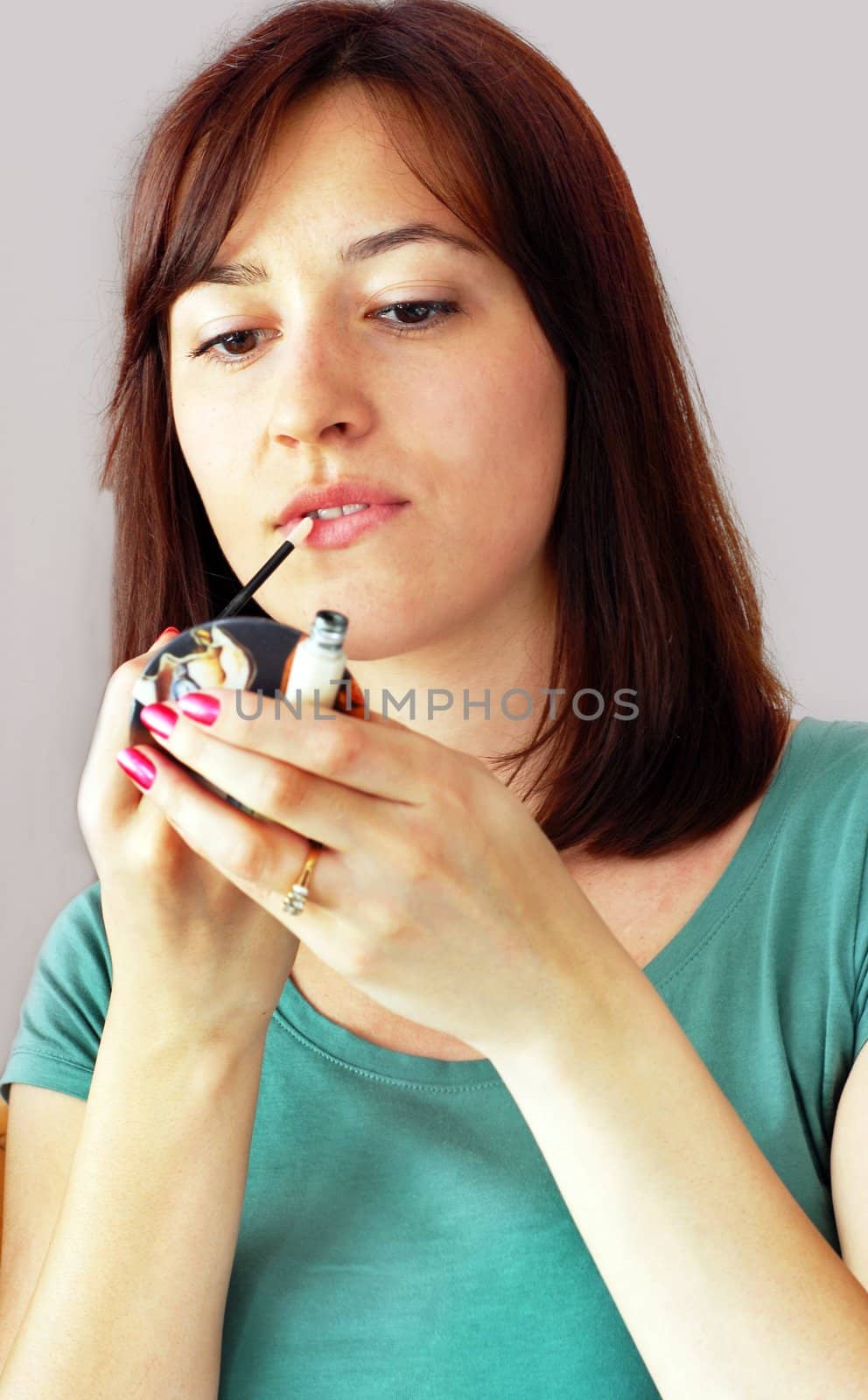 Young woman applying makeup by simply