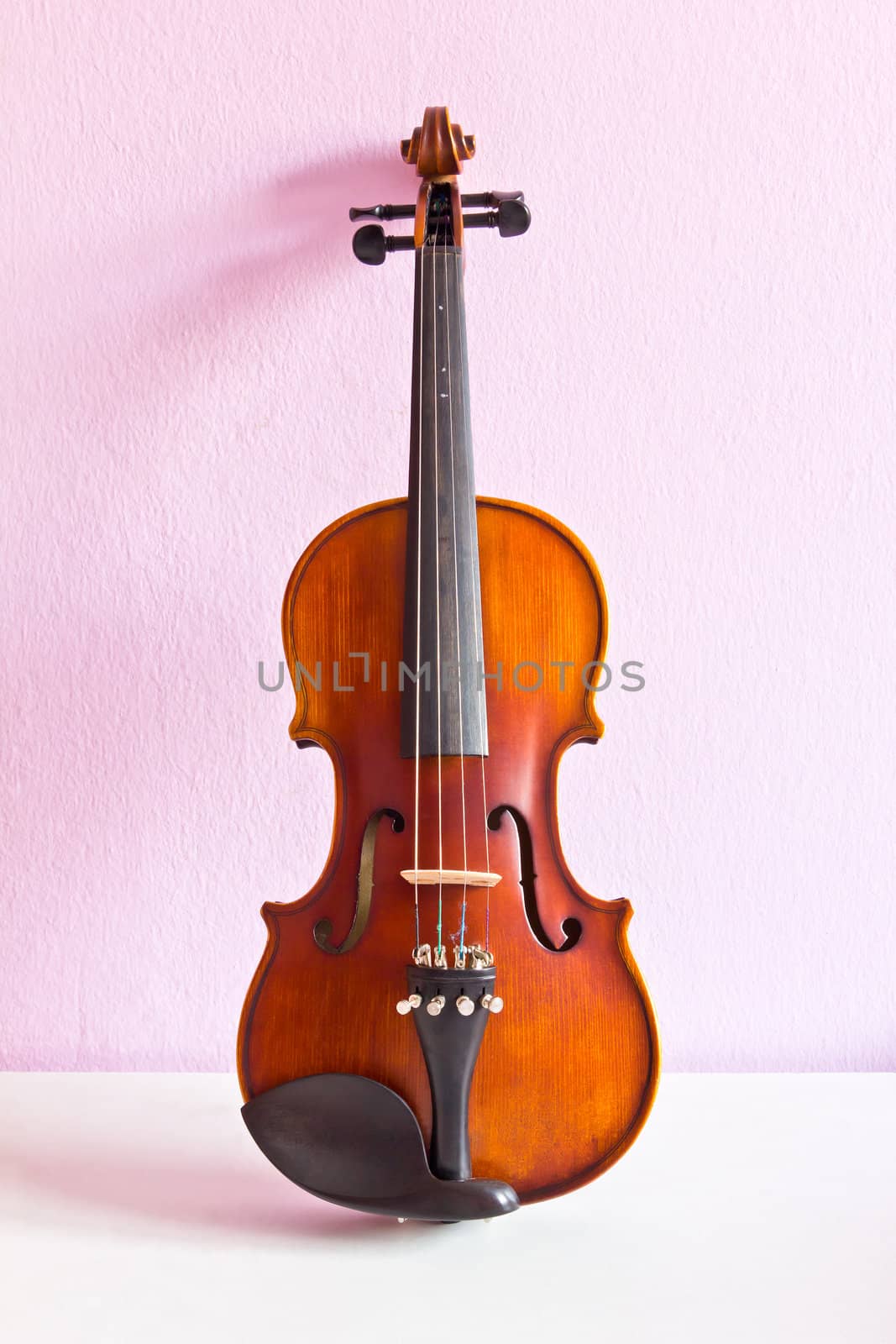 violin on pink wall