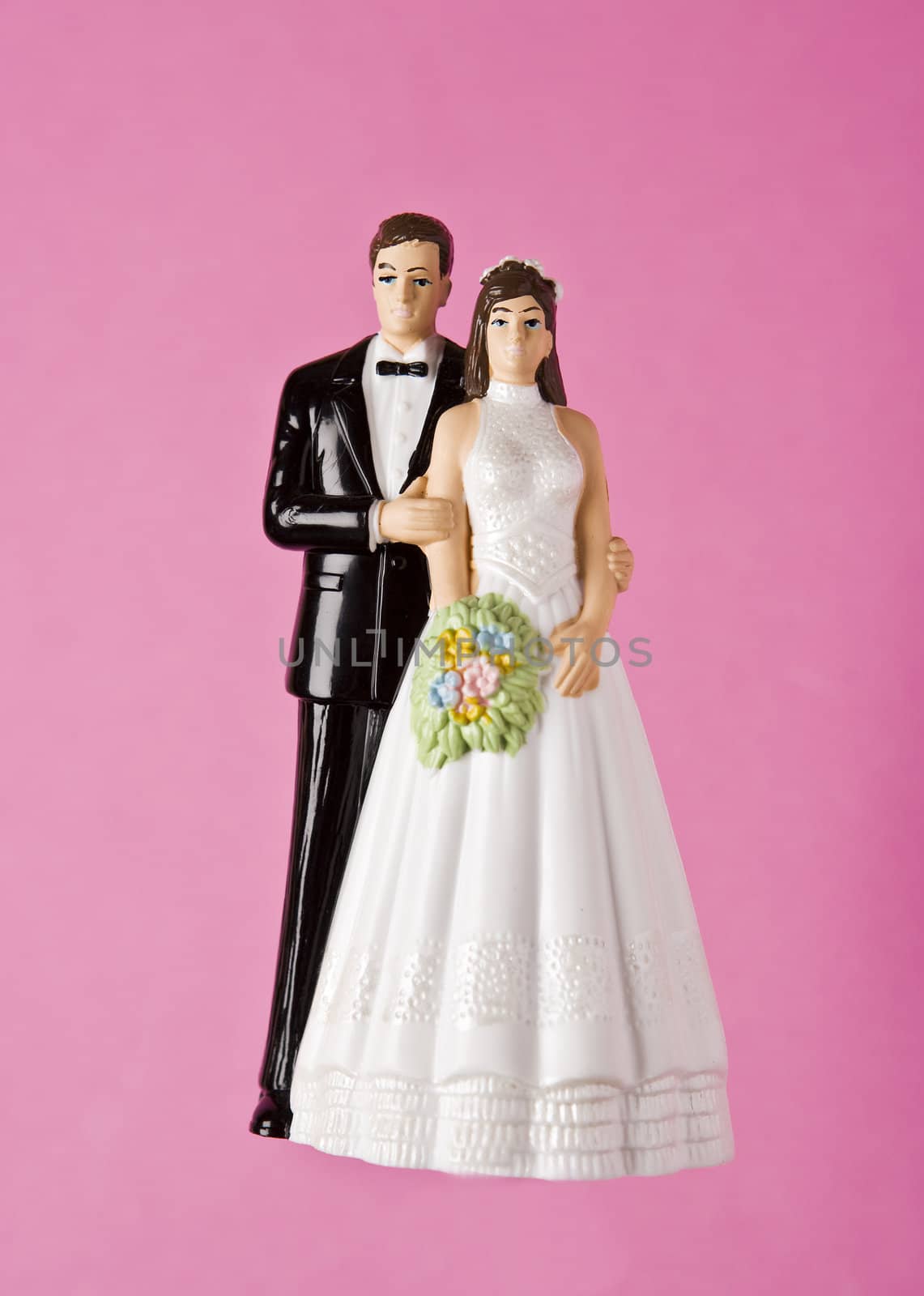 Wedding Figurines towards pink background