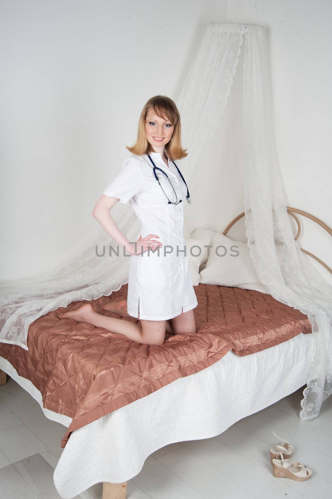 sexy woman doctor on the bed