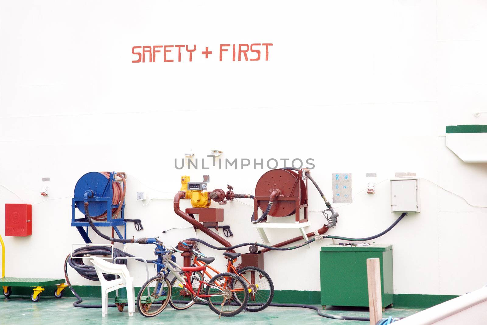 Safety First inscription on the wall and two bikes parked near the pressure pump. Industrial site