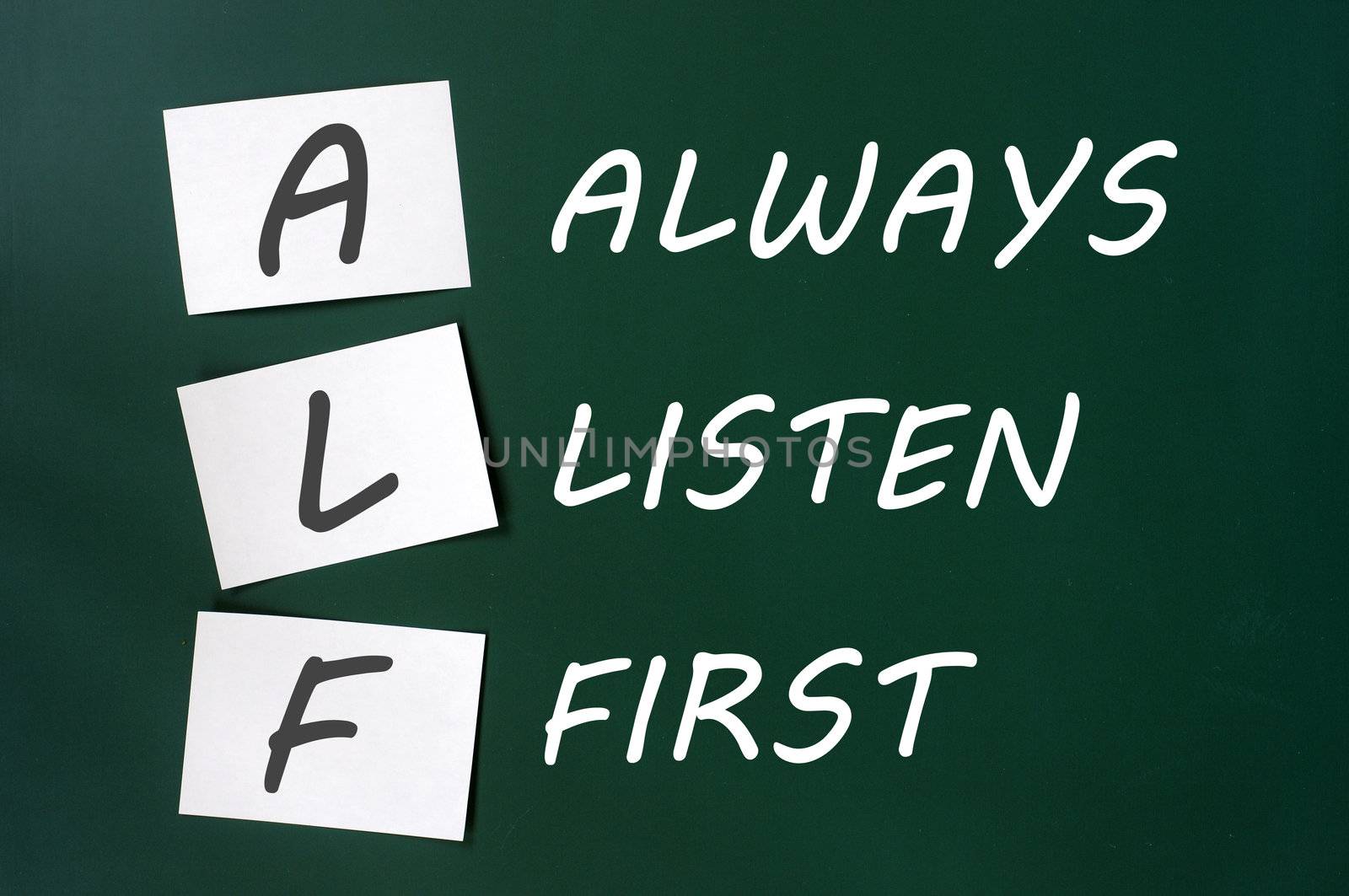 ALF acronym for Always Listen First on a green board