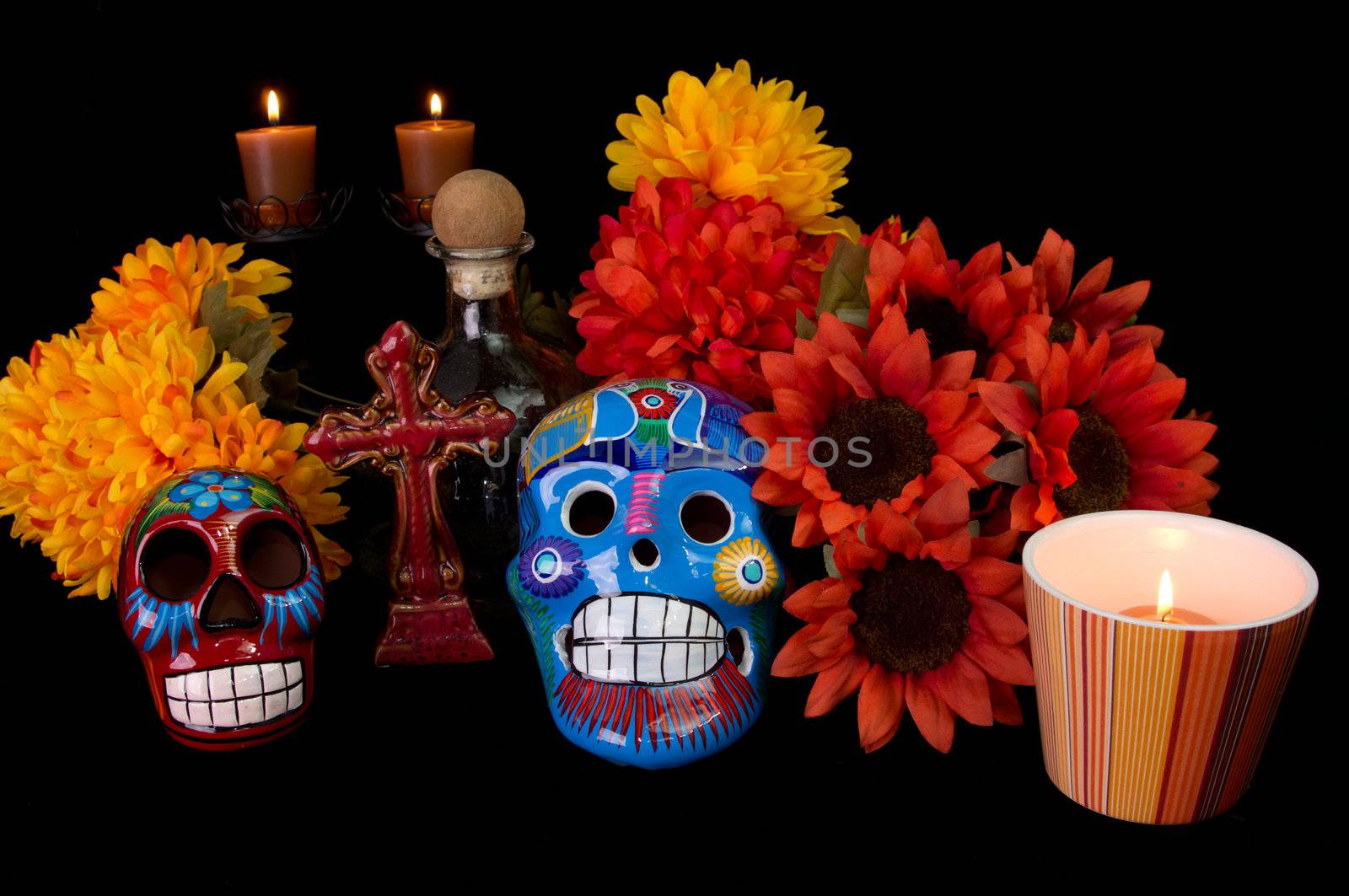 Dia De Los Muertos (Day of the Dead) Alter with decorated sugar skulls, marigold flowers, candles, and cross. Traditional Mexican offering to loved ones