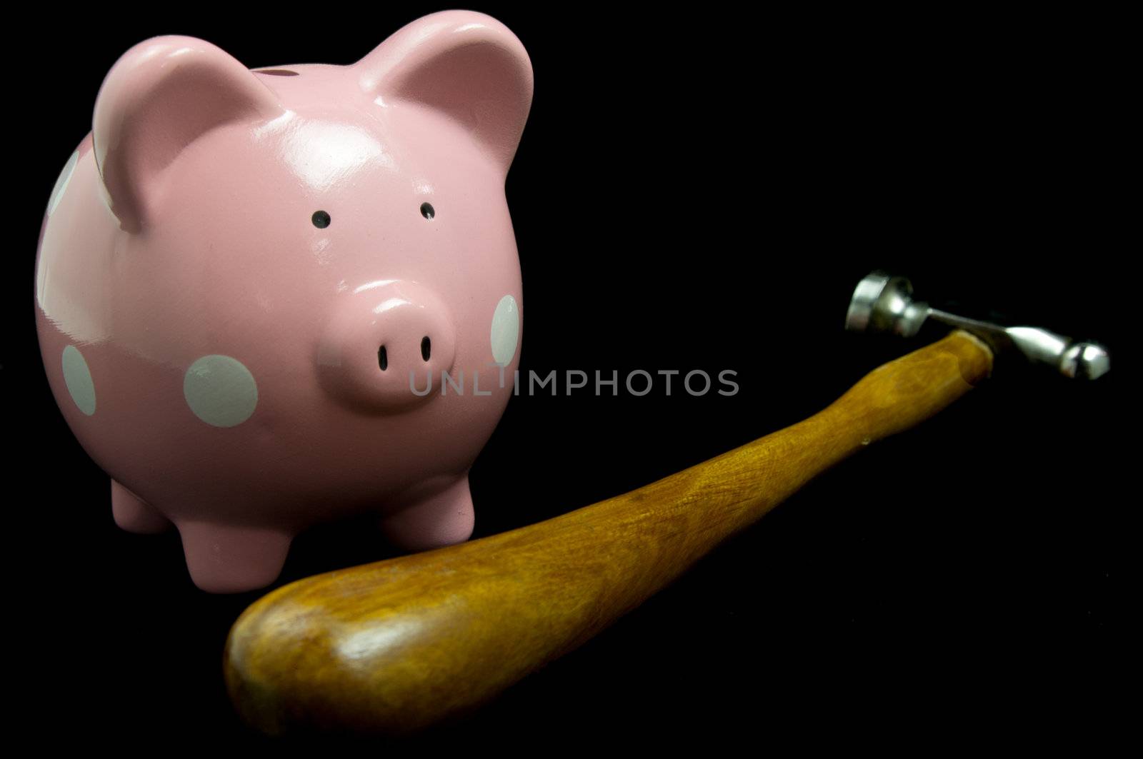 Pink polka dot piggy bank with hammer