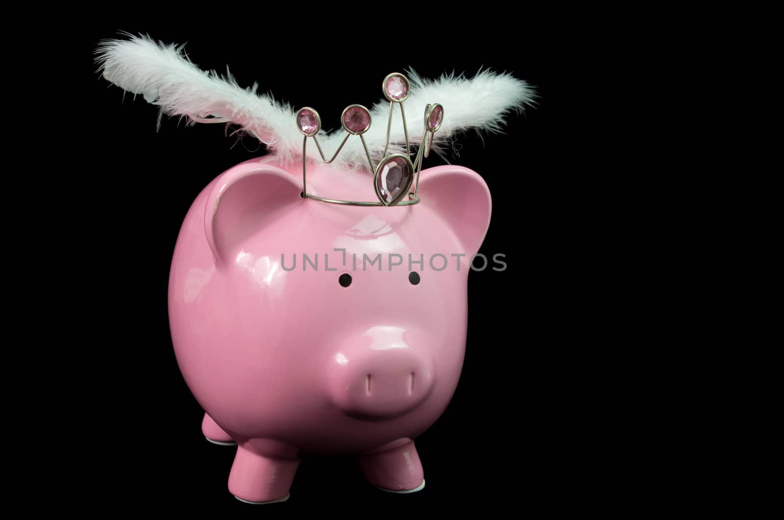 pInk piggy bank with wings on black background