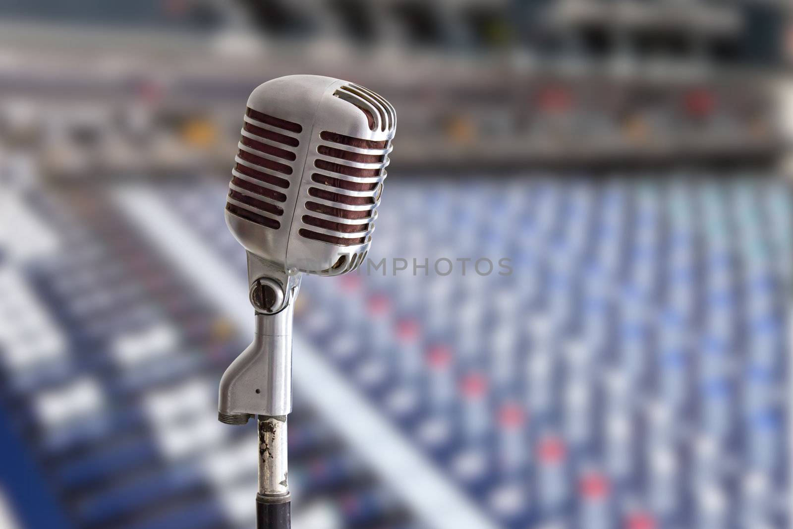 vintage microphone on sound mixer background