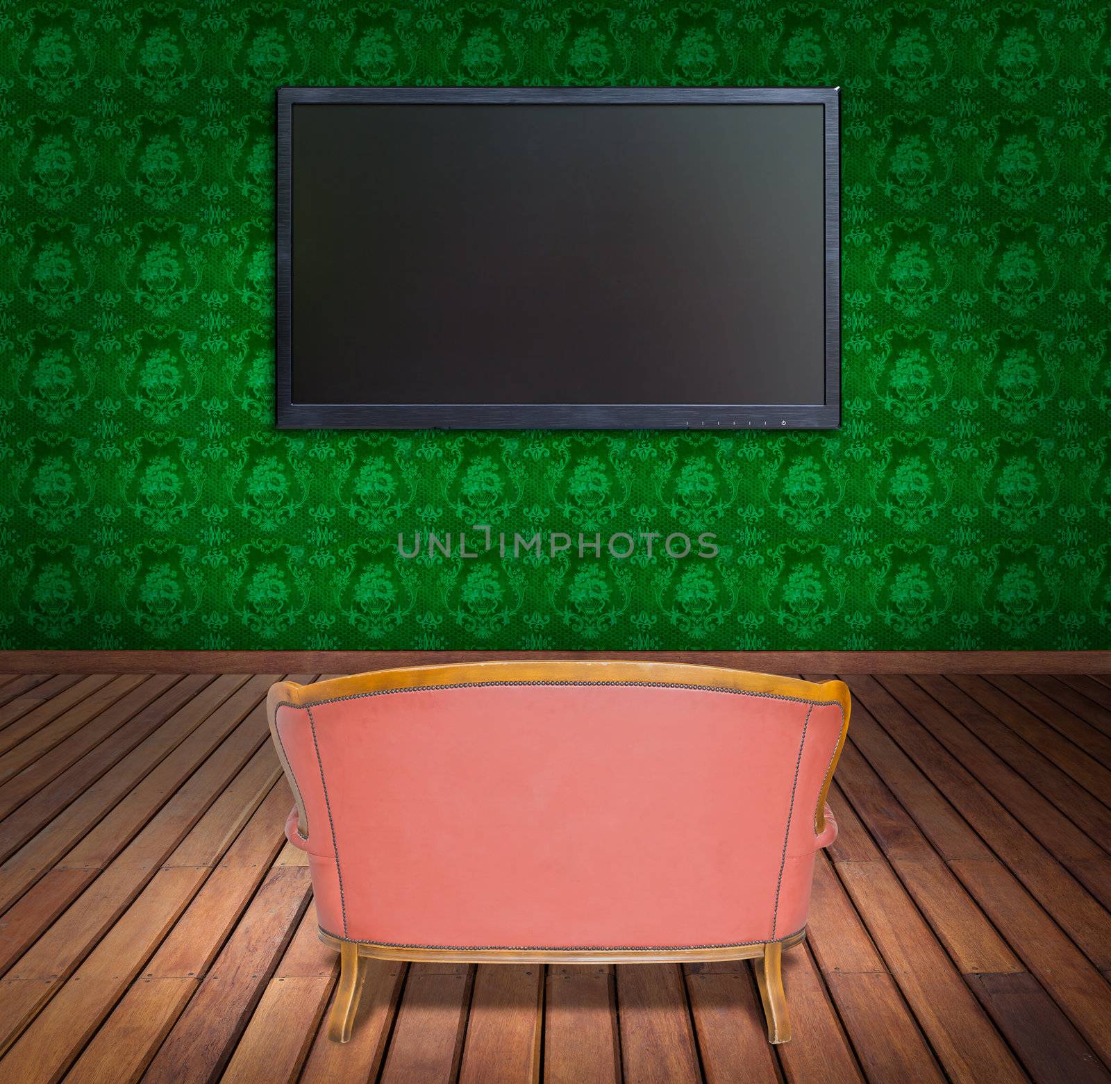 television and sofa in green wallpaper room by tungphoto
