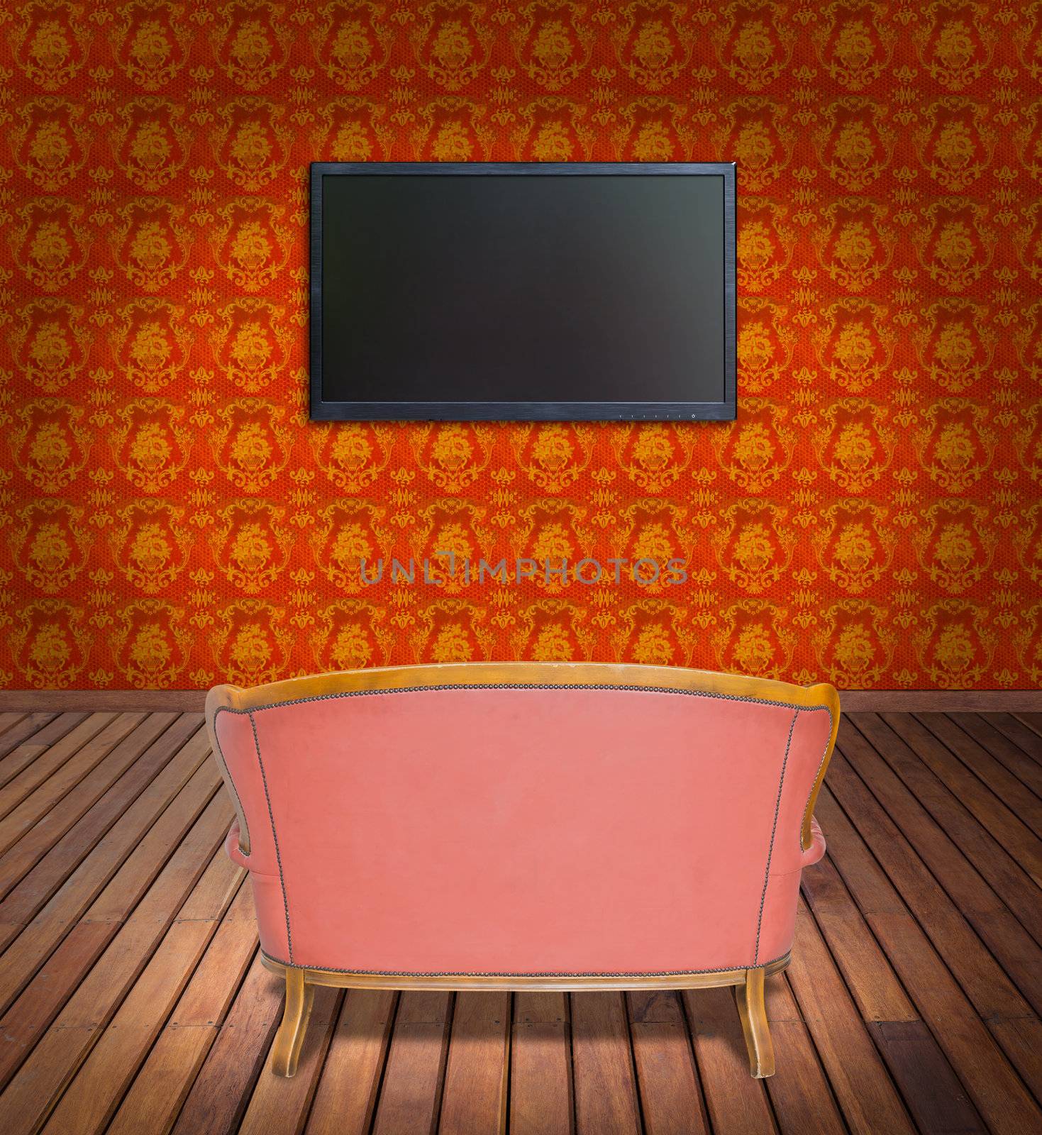 television and sofa in orange wallpaper room by tungphoto