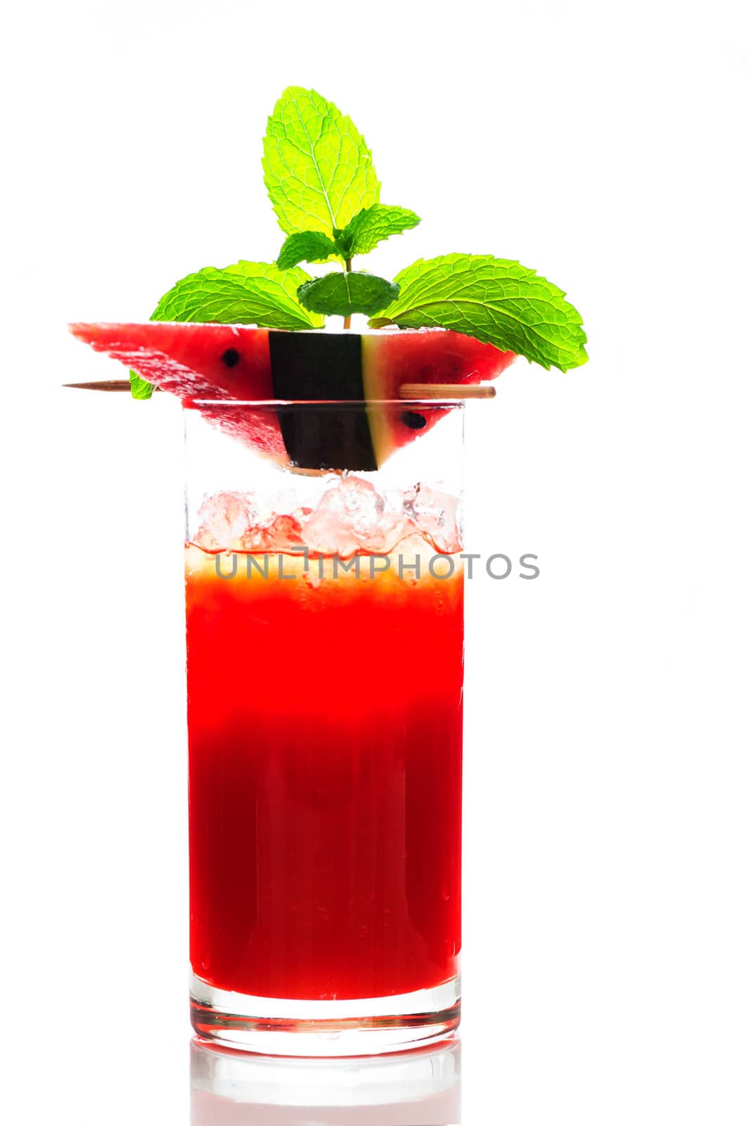 Watermelon smoothie garnished with watermelon slices and mint leaves isolated on white